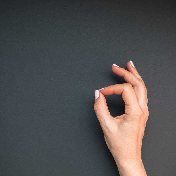 istock Woman's hands with pastel pink manicure 1128000929