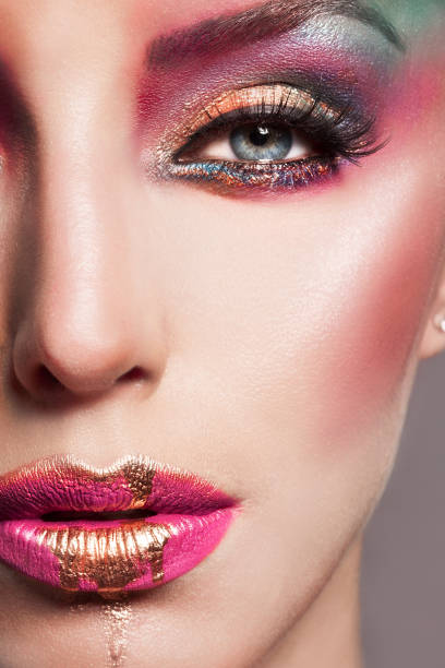 istock Artistic Colorful Make-up Liquid Gold On Lips 1128005514