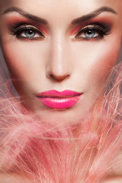 Beautiful Woman Frontal Make-up Close-up With Pink Feathers stock photo