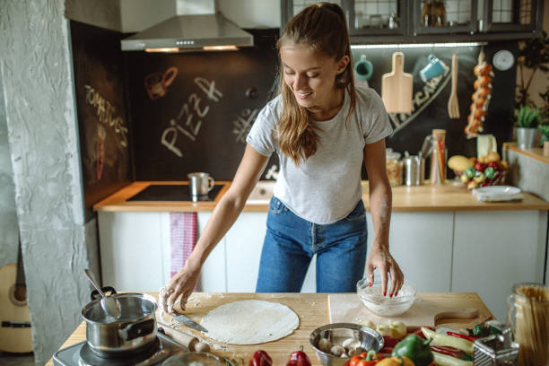 istock Woman preparing dought for pizza 1128006005