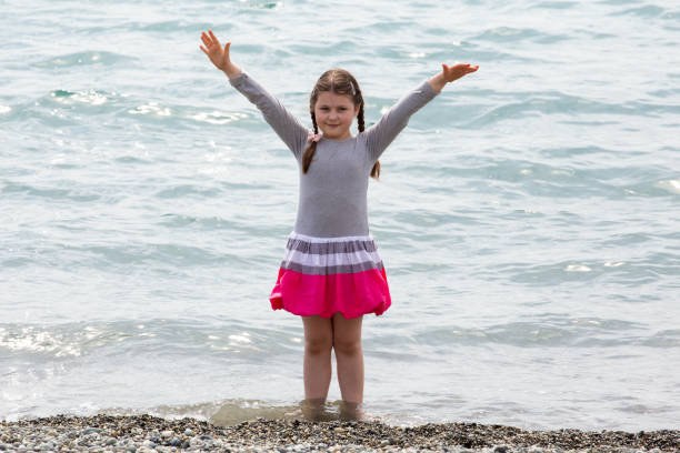 istock a girl on the beach 1128006165