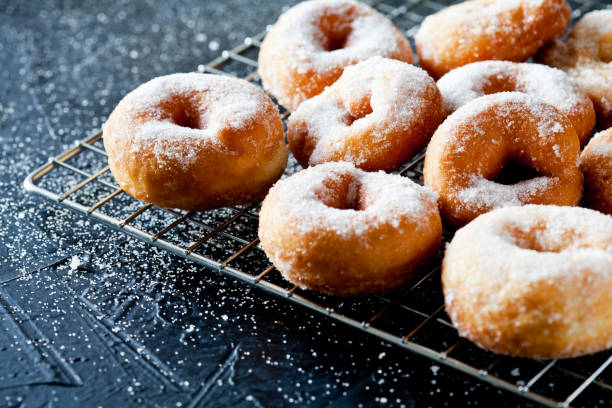 istock Few Donuts With Powdered Sugar On A Cooling Tray 1128006305