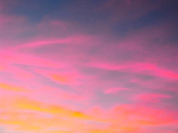 istock Dramatic sunset sky background with fiery clouds, yellow, orange and pink colors 1128008016