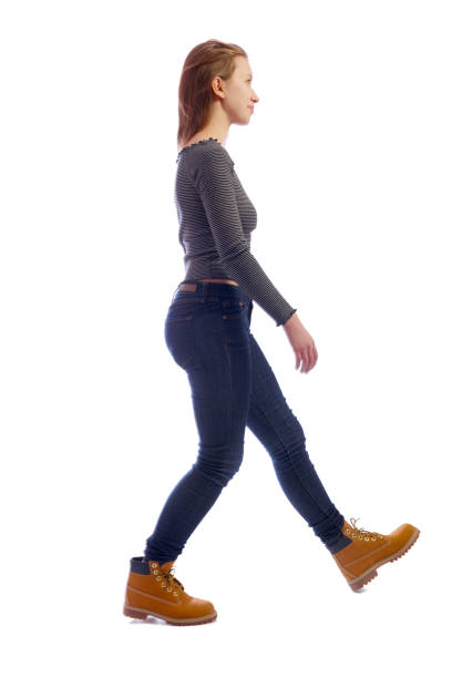 istock side view of walking woman. 1128010806