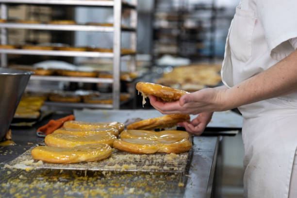 istock artisan pastry chef placing cake on metal tray 1128011030