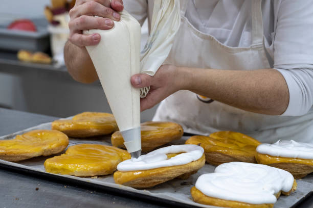 istock pastry decorating cake with cream in a pastry shop 1128011032