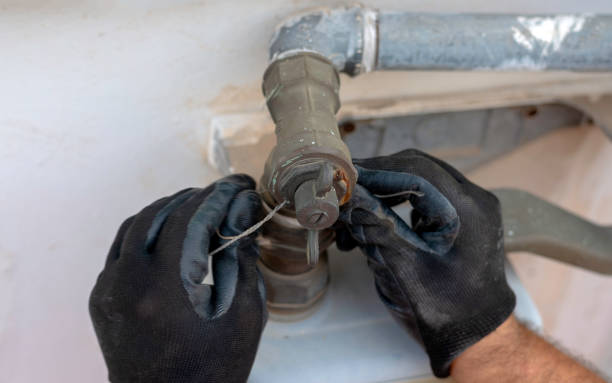 istock Worker removes the seals to the fitting between the pipe and gas meter. Selective focus 1128014983