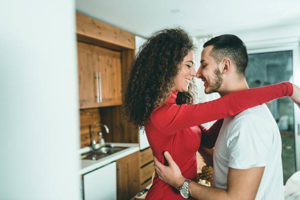 istock Romantic young couple cooking together in the kitchen,having a great time together. 1128015490