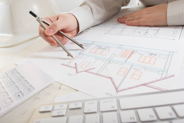 architects working on blueprint, real estate project. architect workplace - architectural project, blueprints, ruler, calculator, laptop and divider compass. construction concept. engineering tools. - housing project organization meeting real estate imagens e fotografias de stock