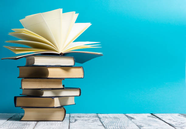 istock Open book, hardback books on wooden table. Back to school. Copy space 1128015961