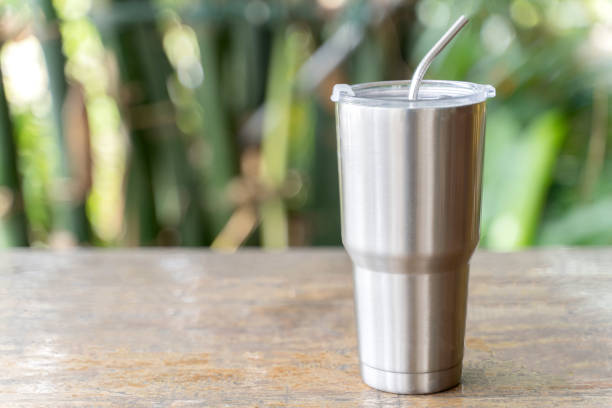 Stainless steel tumbler with stainless straw keeping of the drink cold or hot. Reduce plastic pollution concept. Stainless steel tumbler with stainless straw keeping of the drink cold or hot. Reduce plastic pollution concept. straw stock pictures, royalty-free photos & images