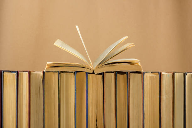 istock Open book, hardback books on wooden table. Back to school. Copy space 1128016233