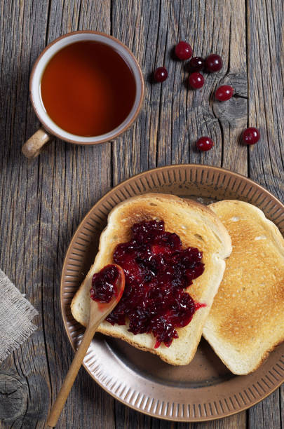 istock Toasted bread with cranberry jam and tea 1128016335