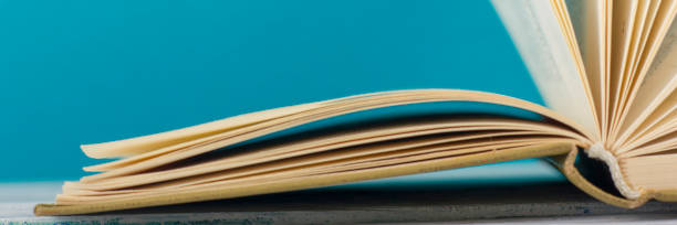 istock Open book, hardback books on wooden table. Back to school. Copy space 1128016960