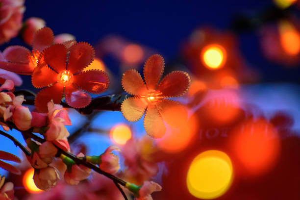 Image of Close up artificial Blossom flower and LED light background.