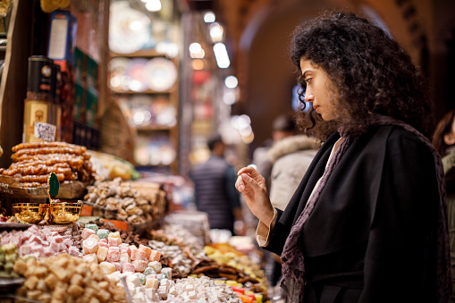 Woman shopping in turkish delight shop in Grand Bazaar, Istanbul, Turkey