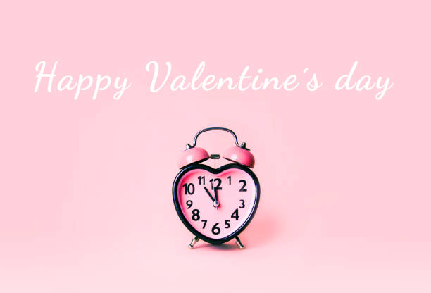 istock Heart shaped clock on pink background. Valentines day and love and duration concept. 1128020110