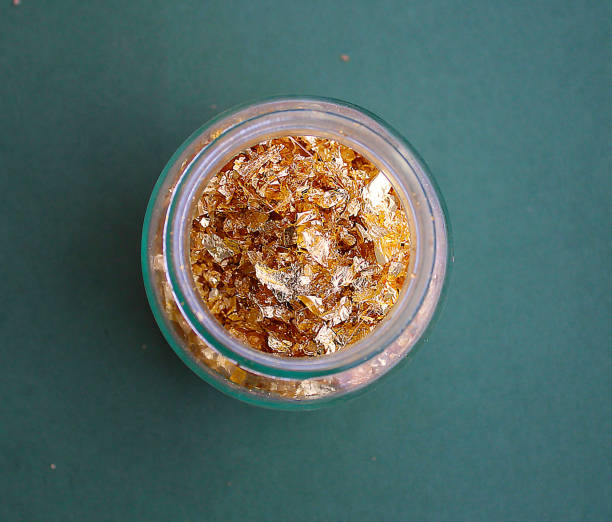 istock Golden leaves in a glass jar 1128023950