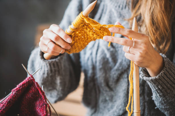 istock Close up on woman's hands knitting 1128025648
