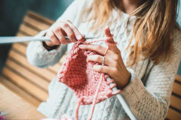 istock Close up on woman's hands knitting 1128025650
