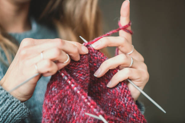 istock Close up on woman's hands knitting 1128025651