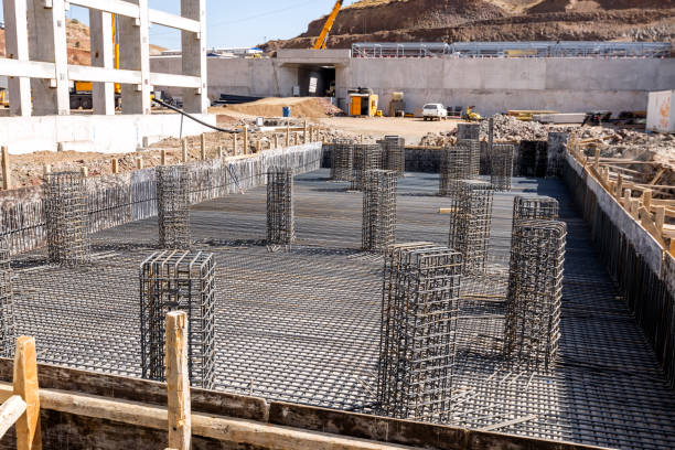View of the rebar beam cages on the foundation for concrete in the construction site. View of the rebar beam cages on the foundation for concrete in the construction site. grill rods stock pictures, royalty-free photos & images