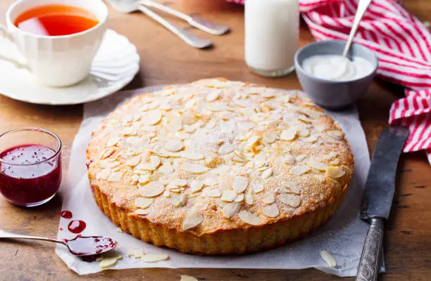 Almond and raspberry cake, Bakewell tart. Traditional British pastry. Wooden background