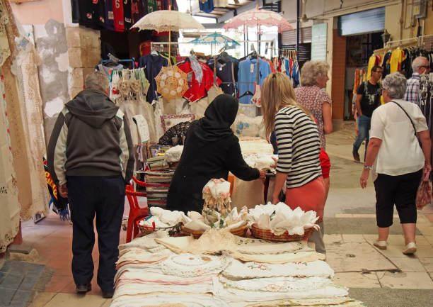 Nicosia, Cyprus - March 17, 2018: stallholders and shopper looking at traditional fabric and lacework in the traditional open market in the turkish area of Nicosia Cyprus