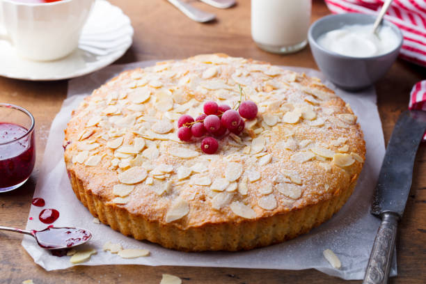Almond and raspberry cake, Bakewell tart. Traditional British pastry. Wooden background. Close up. Almond and raspberry cake, Bakewell tart. Traditional British pastry. Wooden background. Close up bakewell photos stock pictures, royalty-free photos & images