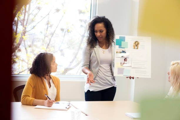 istock Creative professional gives presentation during meeting 1128028640