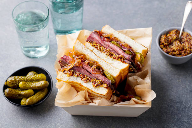 Sandwich with roast beef in wooden box. Grey stone background. Close up. Sandwich with roast beef in wooden box. Grey stone background. Close up sandwich club sandwich lunch restaurant stock pictures, royalty-free photos & images