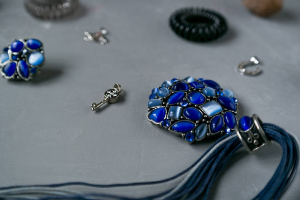 Blue necklace with grey earrings with hair bands and silver pendants