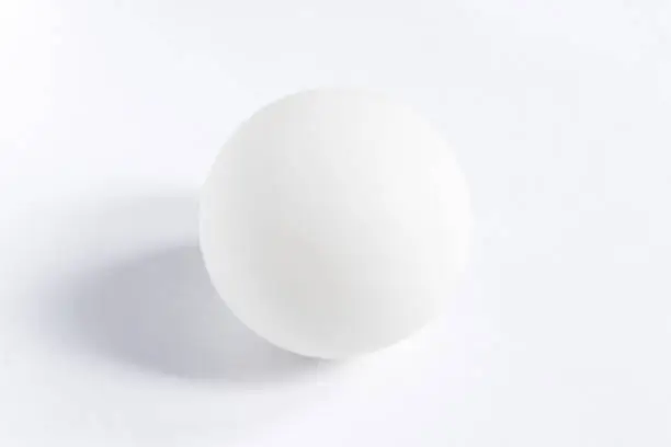 Photo of A perfect white sphere in the center of a white background
