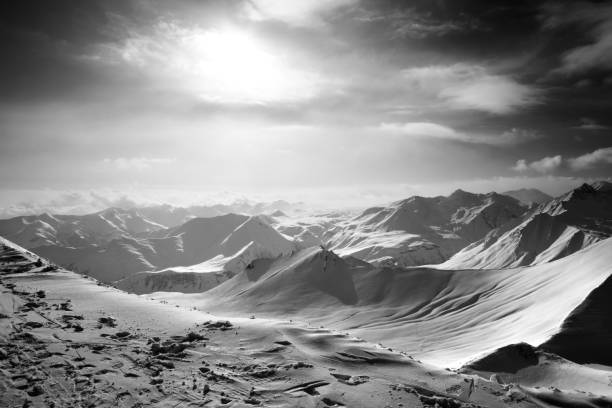 istock Black and white snowy mountains in evening 1128036194