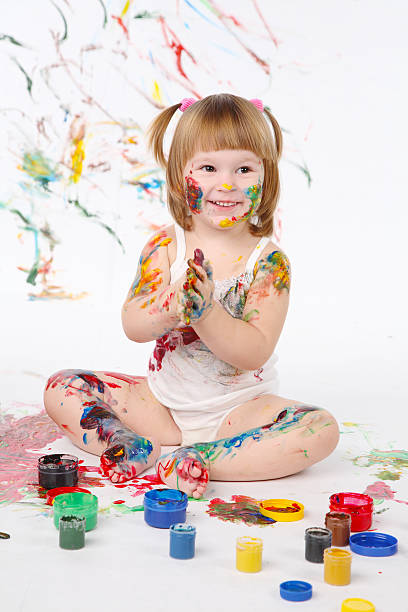 istock little girl bedaubed with bright colors 112804450