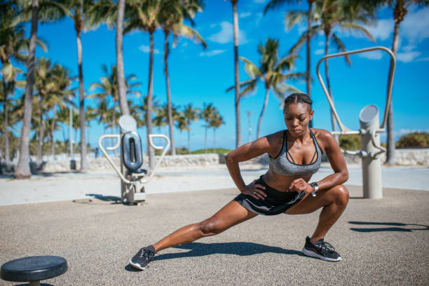 Strong muscular Afro-Latino woman exercising near beach in summer in USA Exercising for healthy lifestyle in USA afro latinx ethnicity stock pictures, royalty-free photos & images