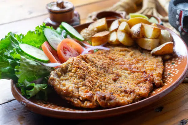 Traditional milanese beef and french fries potatoes