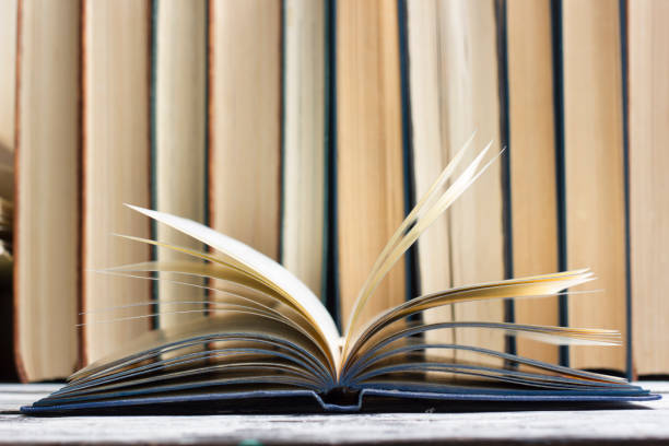 istock Open book, hardback books on wooden table. Back to school. Copy space 1128046508