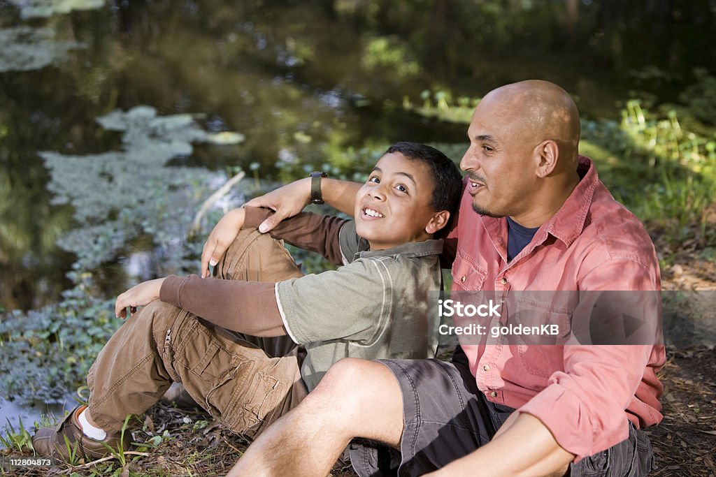 Portrait Hispanic father and son outdoors by pond  Latin American and Hispanic Ethnicity Stock Photo