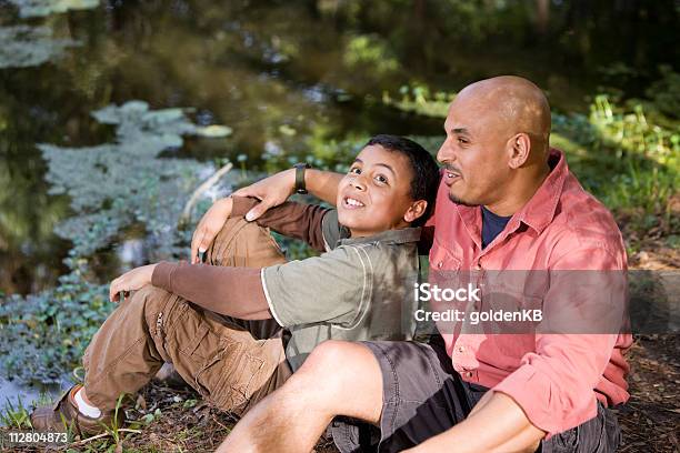 Portrait Hispanic Father And Son Outdoors By Pond Stock Photo - Download Image Now - Latin American and Hispanic Ethnicity, Family, Candid