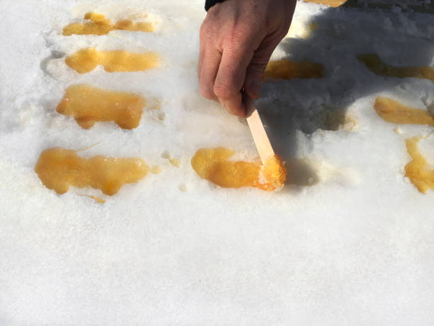 istock Picking Up Maple Taffy From The Snow 1128049289