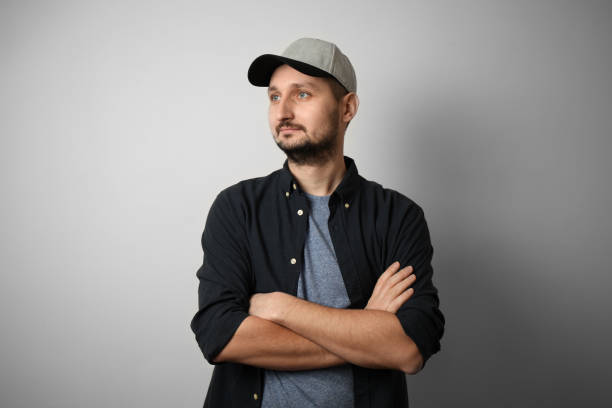 istock Fashionable white man with beard and cap crossed his arms 1128049410