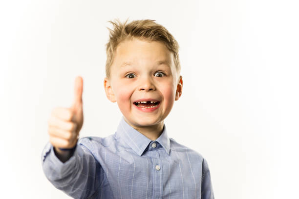 istock happy funny cute boy without front teeth shows hand gesture 1128049705