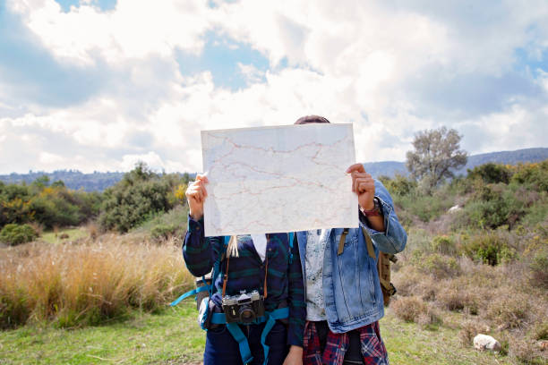 istock Couple hikers with map in mountains 1128050120