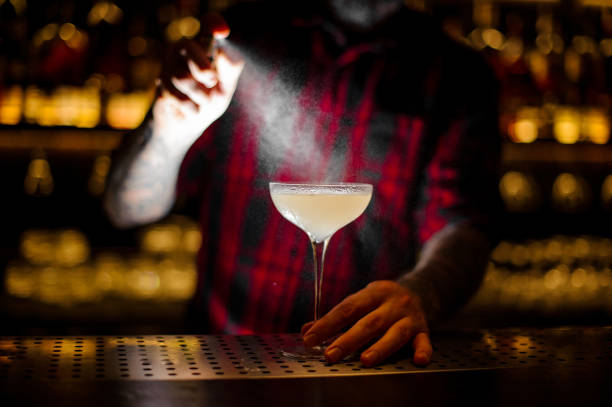 istock Bartender spraying on the delicious Courpse Reviver cocktail from the vaporizer 1128052939