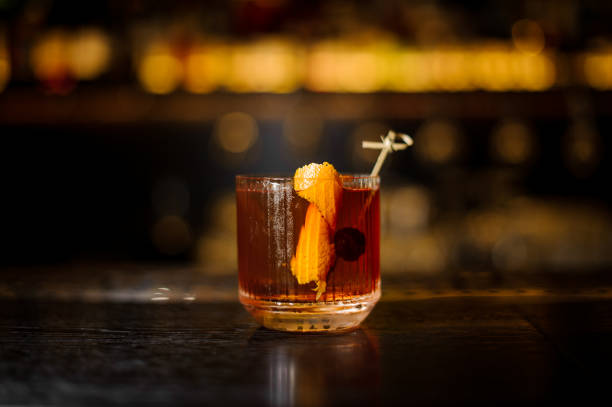 Glass of a Old Fashioned cocktail on the wooden bar counter stock photo