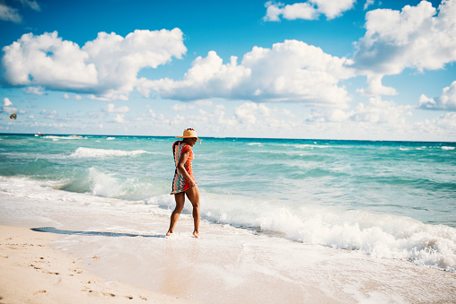 Portrait of beautiful Hispanic woman in bikini at the beach