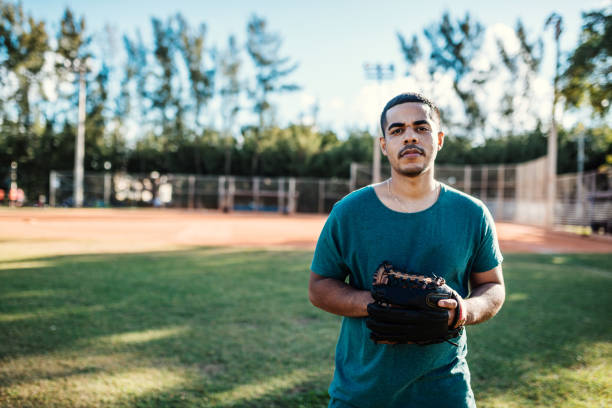 istock Latino baseball player exercising pitching in USA 1128055426