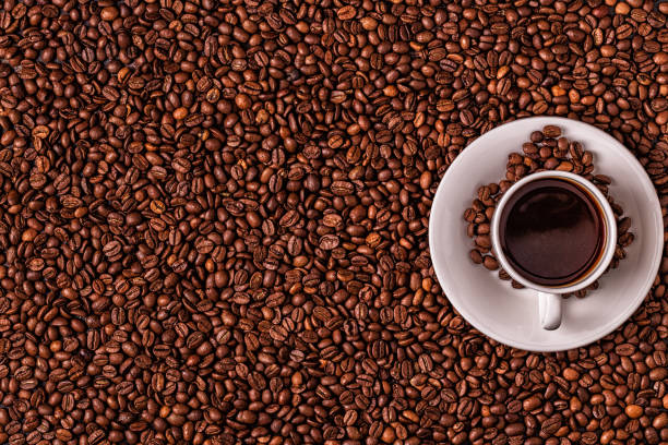 istock Cup of coffee on a background of coffee beans 1128055545