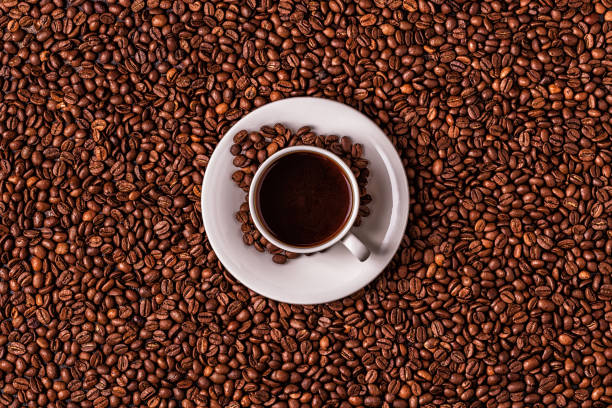 istock Cup of coffee on a background of coffee beans 1128055564
